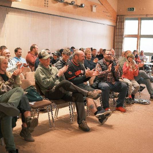 A group at an auditorium listening to a lecture