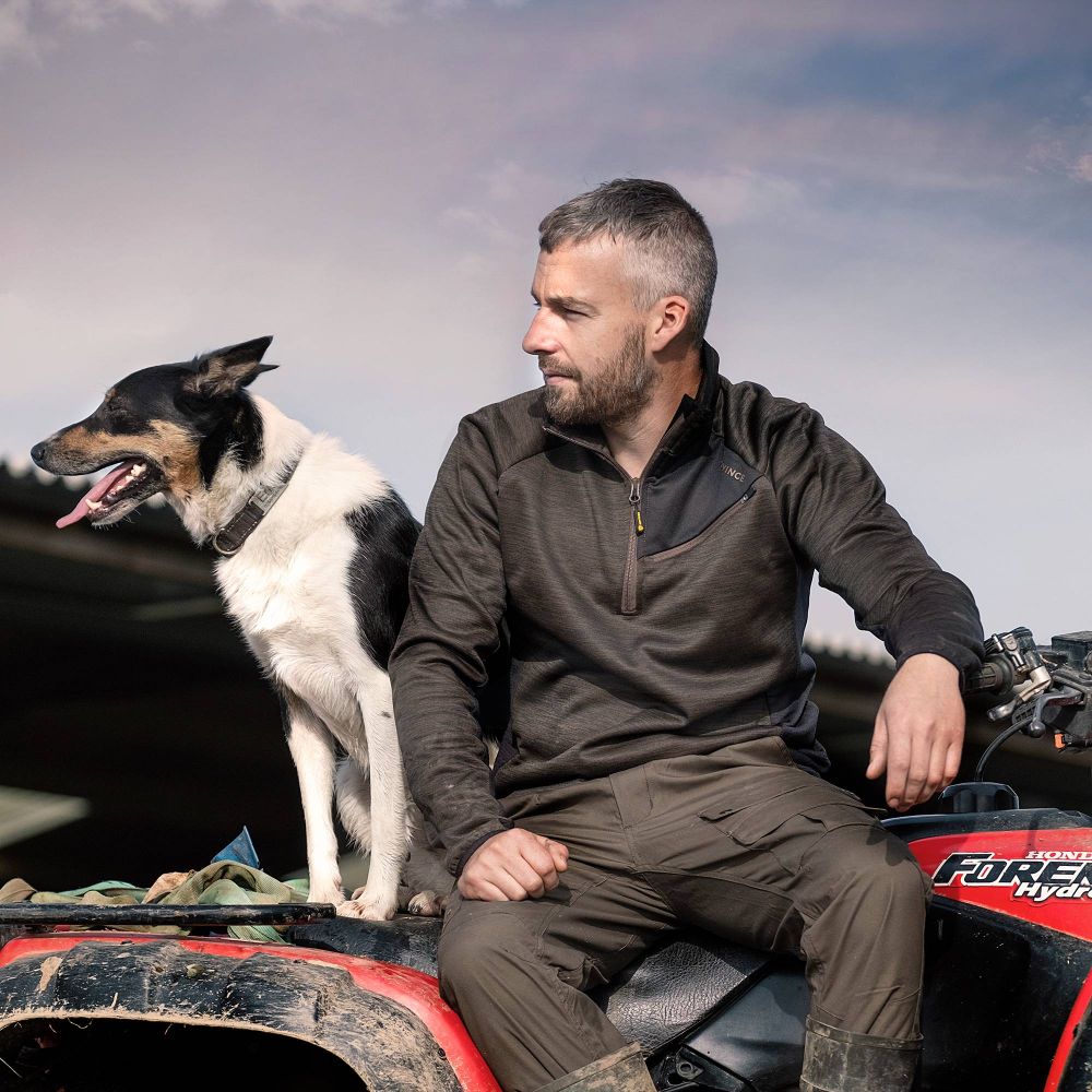 Man on a quad bike with his dog