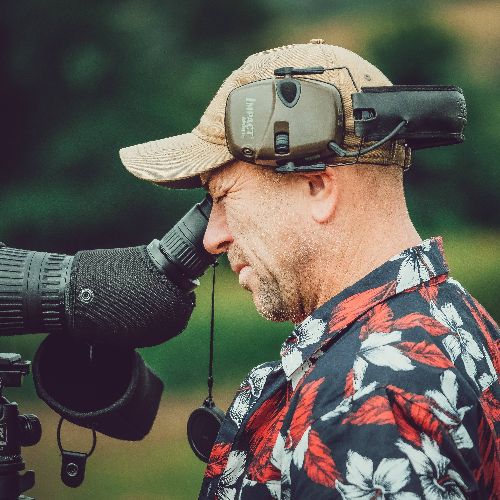 An individual looking through a binocular set